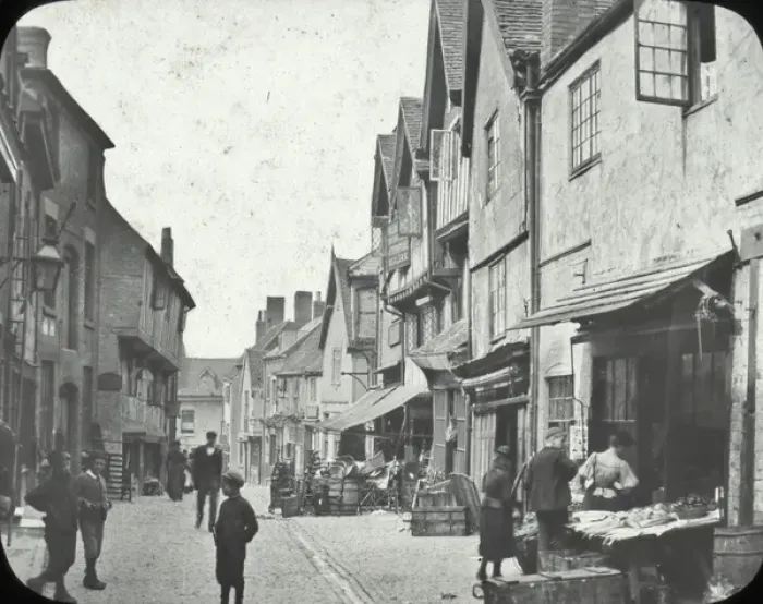 Framed Print : Coventry - view along Street, shops, goods? on pavement, people Framed Print : Coventry - view along Street, shops, goods? on pavement, people