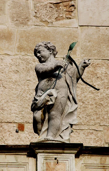 Cupid with bow and arrows. Sculpture. Facade of the Duomo in