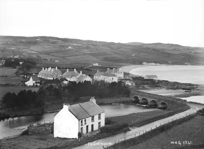 Framed Print : Cushendun - an elevated view of the river and bridge and buildings around Framed Print : Cushendun - an elevated view of the river and bridge and buildings around