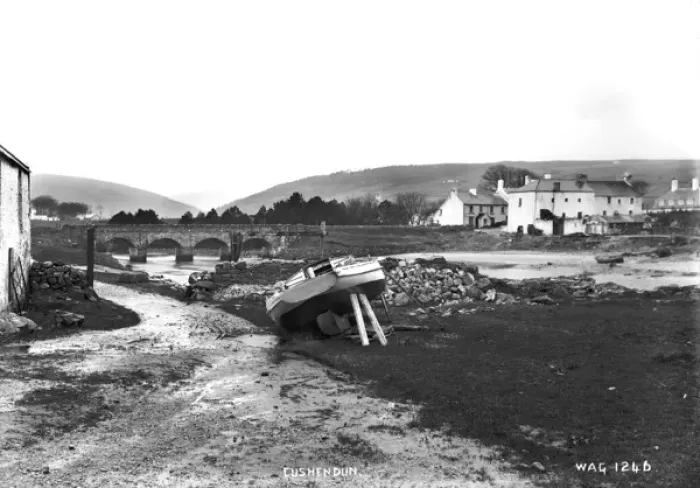Framed Print : Cushendun - a view from the shore looking up to the bridge with a boat in the foreground Framed Print : Cushendun - a view from the shore looking up to the bridge with a boat in the foreground