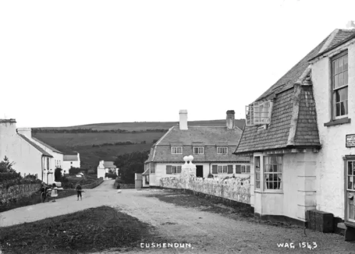 Framed Print : Cushendun - a view of the buildings and children in the street Framed Print : Cushendun - a view of the buildings and children in the street