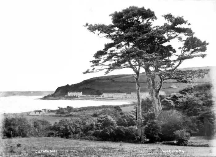Framed Print : Cushendun - a view of the town, taken from a distance, with a tree in the foreground Framed Print : Cushendun - a view of the town, taken from a distance, with a tree in the foreground