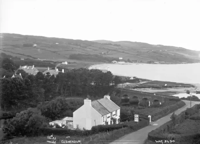 Framed Print : Cushendun - an elevated view looking down on the village and stone bridge and bay Framed Print : Cushendun - an elevated view looking down on the village and stone bridge and bay
