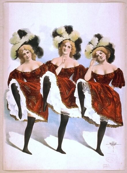 Three dancing women in red costumes and feathers