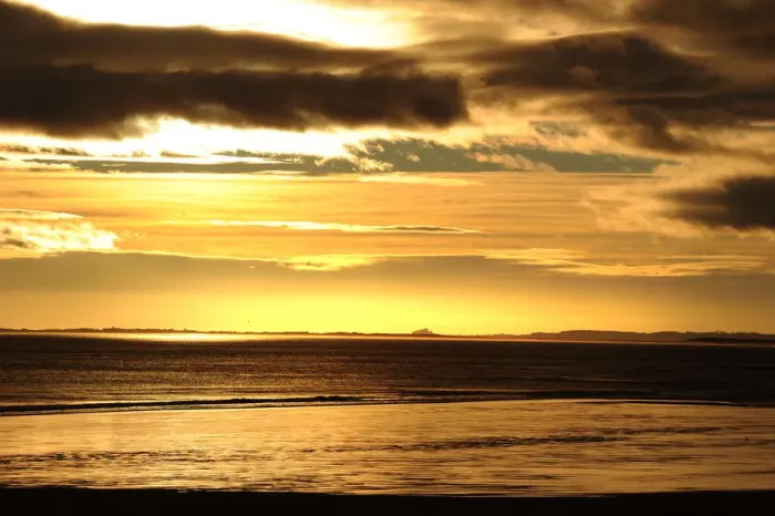 Framed Print : Dark stormy skies above Bamburgh Castle, Northumberland