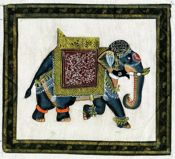 An elaborately decorated Indian elephant adorned with jeweled cloth and silver bangles at a celebration India Stock Photo