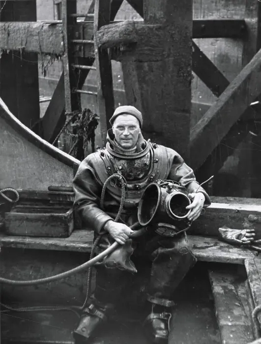 Framed Print : A deep sea diver in Plymouth Docks, taking a rest break, his heavy helmet resting on his knee. Date: 1960 Framed Print : A deep sea diver in Plymouth Docks, taking a rest break, his heavy helmet resting on his knee. Date: 1960