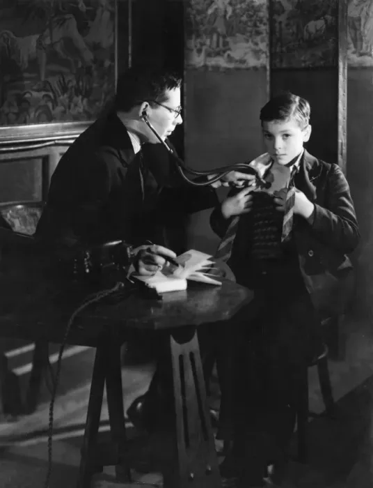Framed Print : Doctor with stethoscope examines boy Framed Print : Doctor with stethoscope examines boy