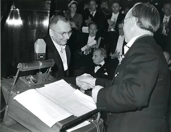 Dr Hugh Dryden, left, is presented with his certificate ?