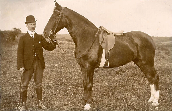 Well dressed man with saddled horse