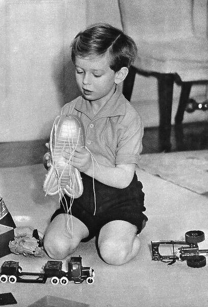 Duke of Kent as a boy with barrage balloon toy