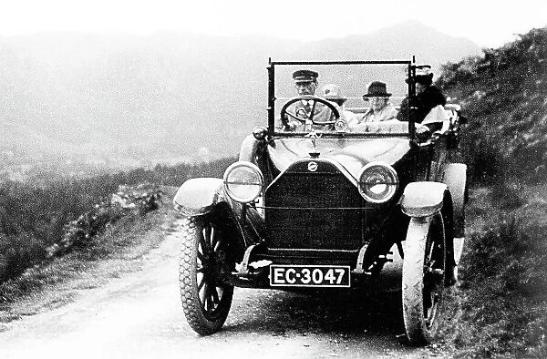 Early motor car with chauffeur
