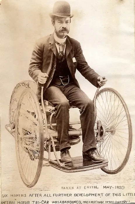 : Edward Butler steering his petrol Tri-car : Edward Butler steering his petrol Tri-car