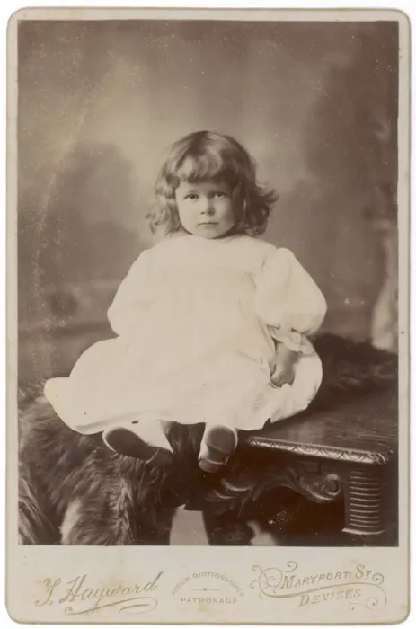 Framed Print : Edwardian girl sitting on a table Framed Print : Edwardian girl sitting on a table