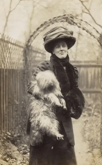 Framed Print : Edwardian woman holding a terrier in a garden Framed Print : Edwardian woman holding a terrier in a garden