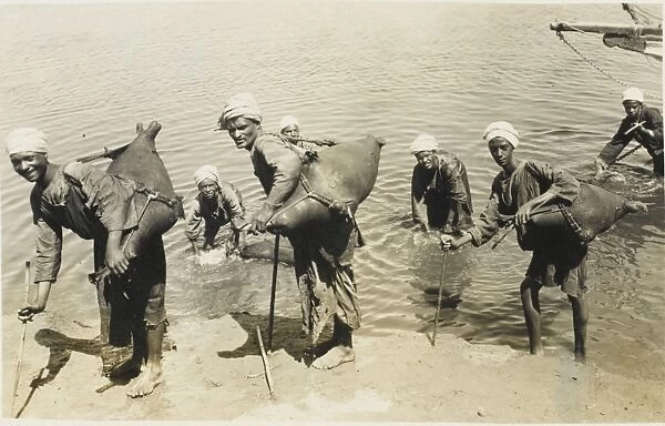 Egypt - River Nile - Water carriers fill their water skins