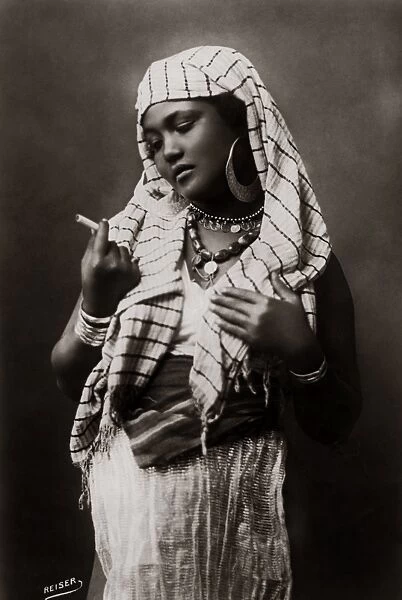Egyptian girl with cigarette, Egypt, circa 1910
