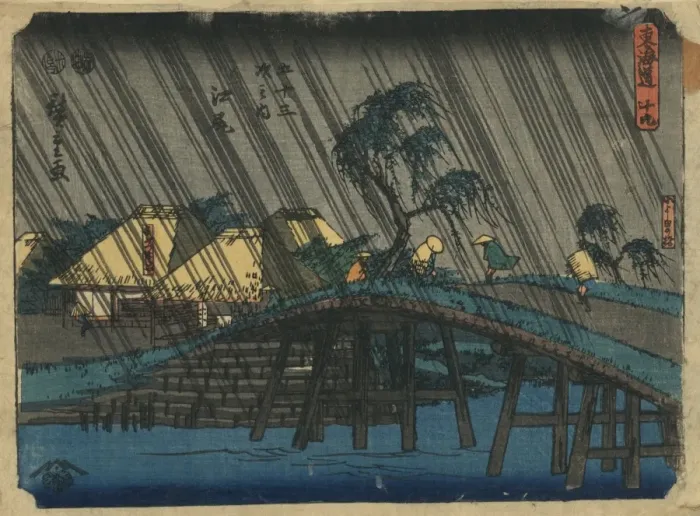 Framed Print : Ejiri. Print shows travelers crossing a bridge during a rain storm at the Framed Print : Ejiri. Print shows travelers crossing a bridge during a rain storm at the