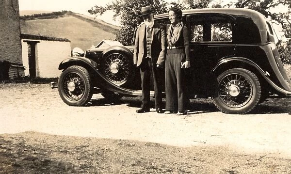 Elderly couple and their Armstrong Siddeley car