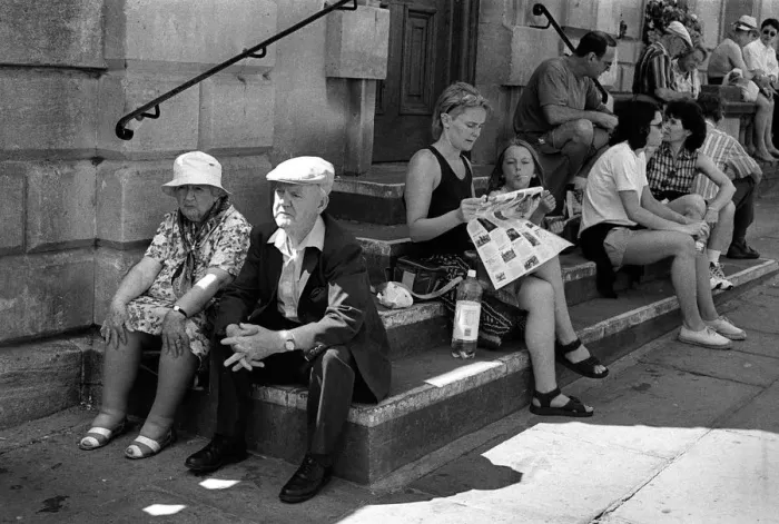 Framed Print : An elderly couple sitting on steps outside Bath Abbey Framed Print : An elderly couple sitting on steps outside Bath Abbey