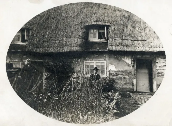 Framed Print : Elderly couple standing proudly outside their thatched English country cottage Framed Print : Elderly couple standing proudly outside their thatched English country cottage