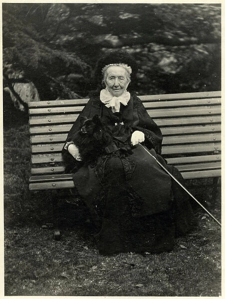 Elderly woman on a bench with her dog