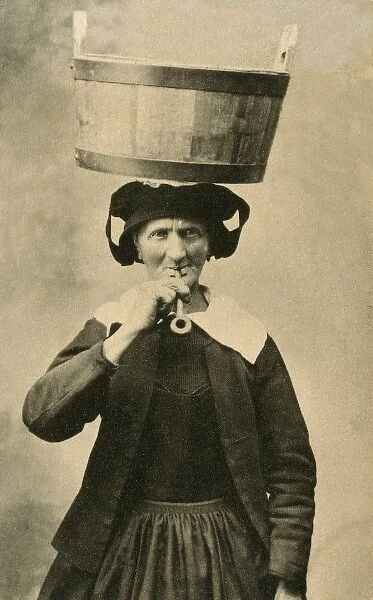 Elderly woman with a bucket on her head