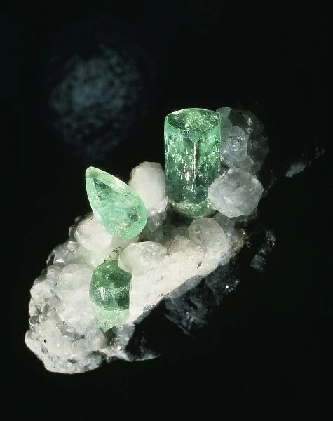 Emerald crystals and cut stone