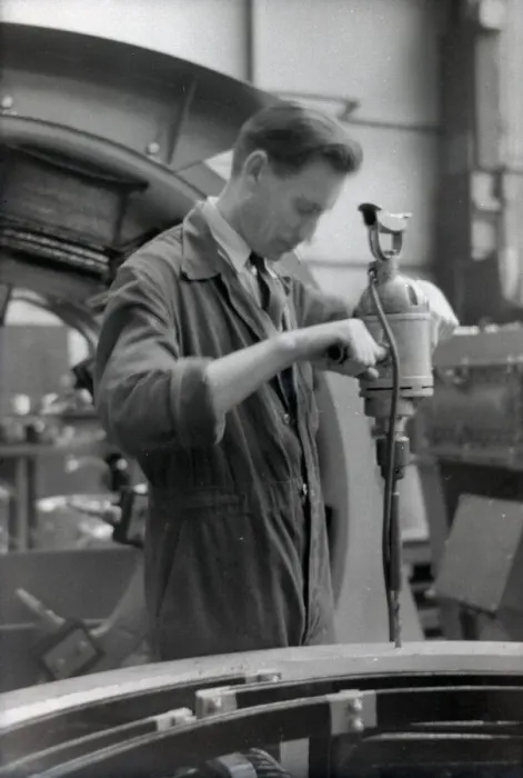 Framed Print : An engineer in overalls working with a large hand drill Framed Print : An engineer in overalls working with a large hand drill