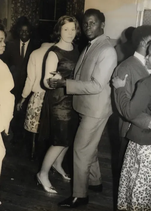 Framed Print : English girl and African man with other people on the dance Framed Print : English girl and African man with other people on the dance