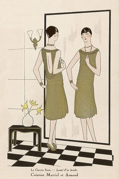 Evening Dress 1926. A lady looks in a mirror, admiring the creation in