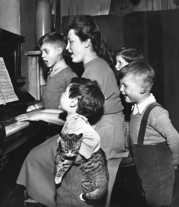 Framed Print : Family and cat practising Christmas carols at the piano Framed Print : Family and cat practising Christmas carols at the piano