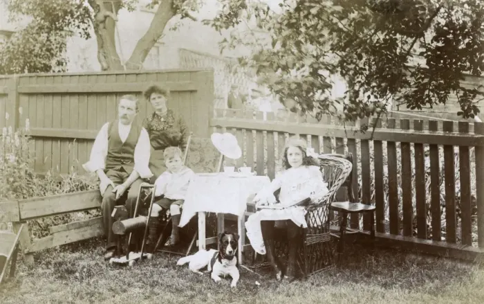 Framed Print : Family of four and a dog in a garden Framed Print : Family of four and a dog in a garden