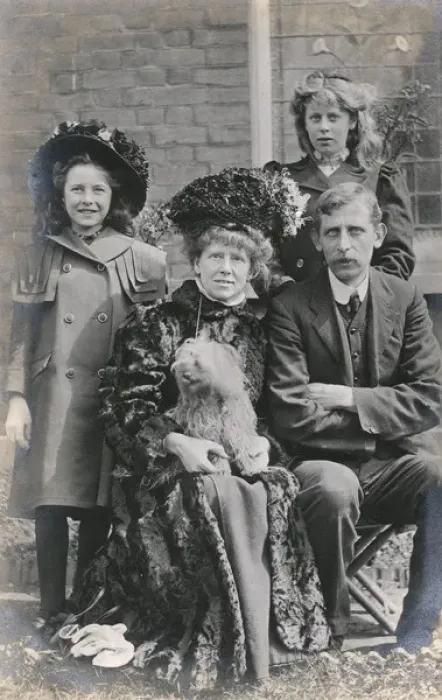 Framed Print : Family of four with a dog in a garden Framed Print : Family of four with a dog in a garden