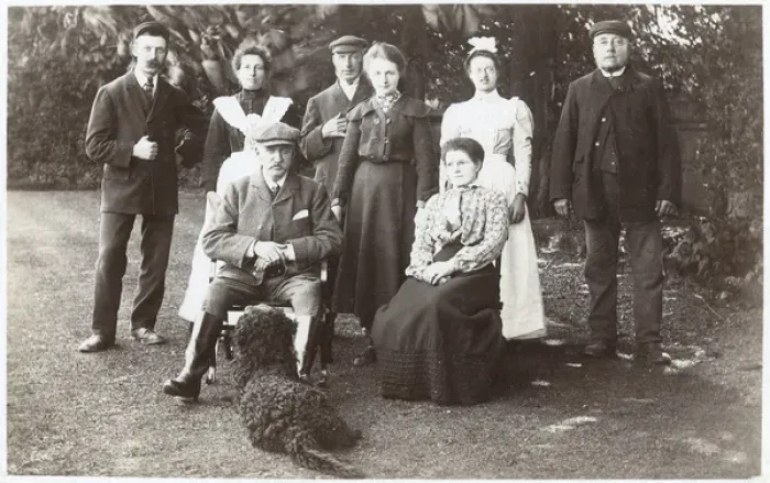 Framed Print : Family group with black poodle in a garden Framed Print : Family group with black poodle in a garden