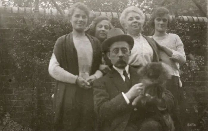 Framed Print : Family group with dog in a garden