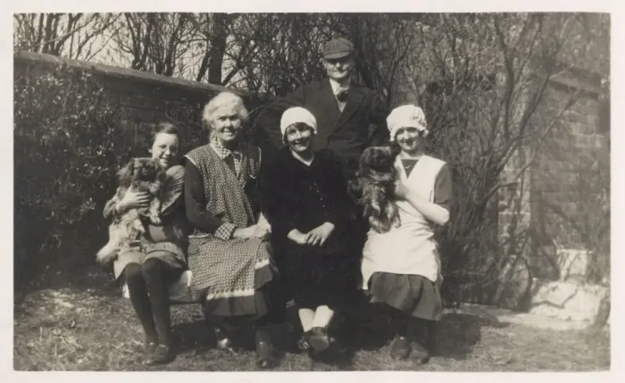 Framed Print : Family group with two dogs in a garden Framed Print : Family group with two dogs in a garden