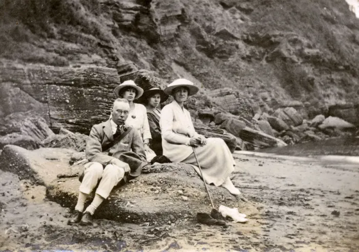 Framed Print : Family group sitting on a beach at the seaside Framed Print : Family group sitting on a beach at the seaside
