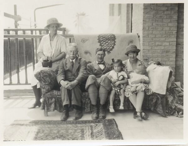Family group on a sofa on a verandah