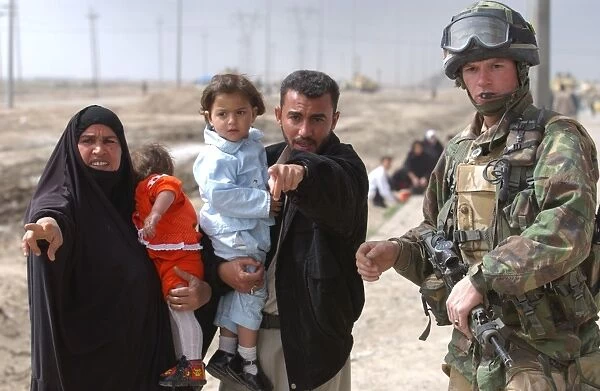 A family of Iraqi civilians seek the help of a soldier