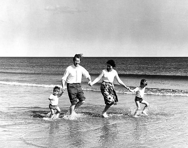 Family of four paddling in the sea