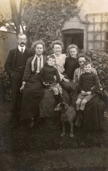 Family of seven with a dog in a garden