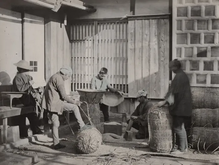 Framed Print : Farm workers packing bales of rice, Japan