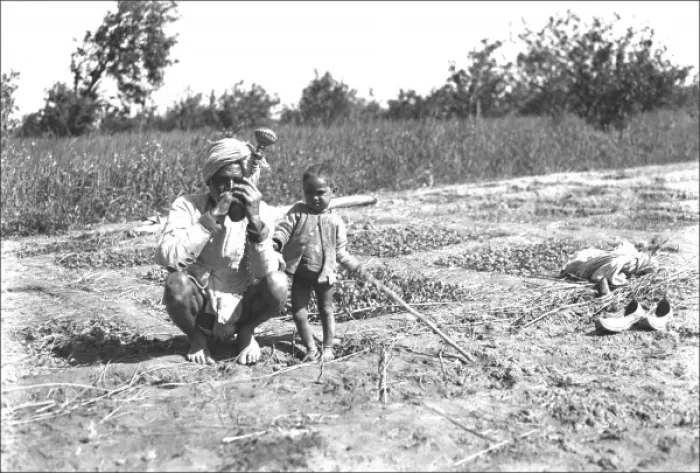 Framed Print : Father and child in a field, India Framed Print : Father and child in a field, India