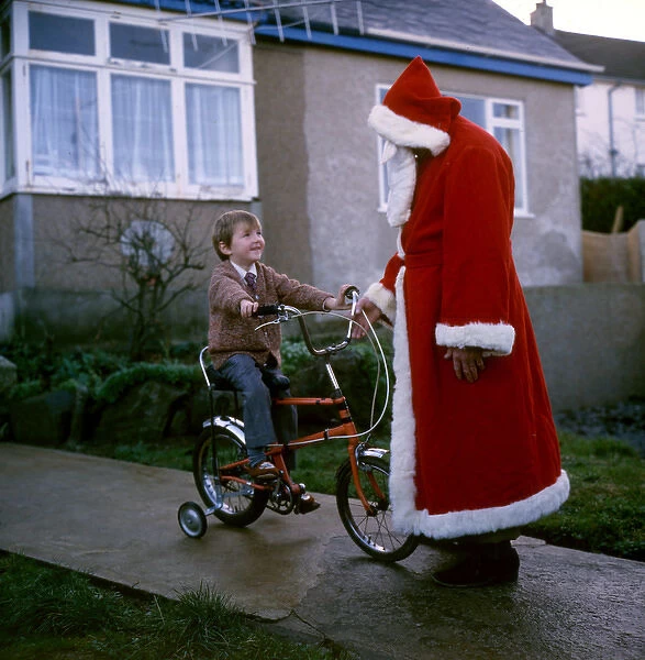 Father Christmas chats to boy on bike