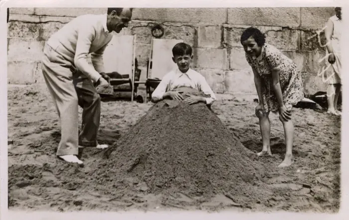 Framed Print : Father and daughter bury son (brother), British seaside Framed Print : Father and daughter bury son (brother), British seaside