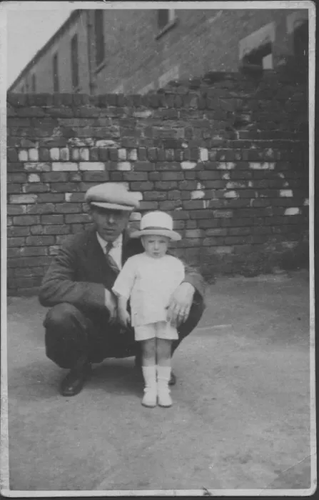 Framed Print : A father poses with his little boy in a back street. Date: 1920s Framed Print : A father poses with his little boy in a back street. Date: 1920s