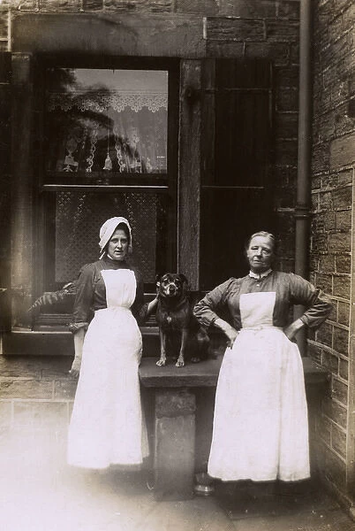 Two female servants and dog in yard