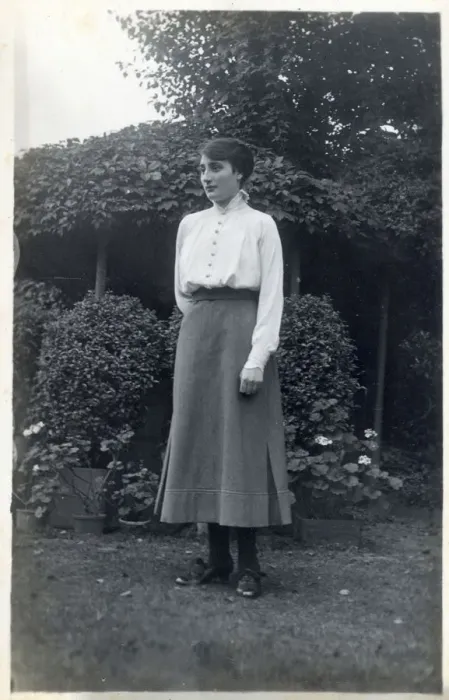 Framed Print : A female student (?) posing for a photograph in a suburban garden. circa 1910s Framed Print : A female student (?) posing for a photograph in a suburban garden. circa 1910s