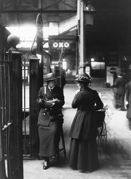 A female ticket collector at platform five in a London train